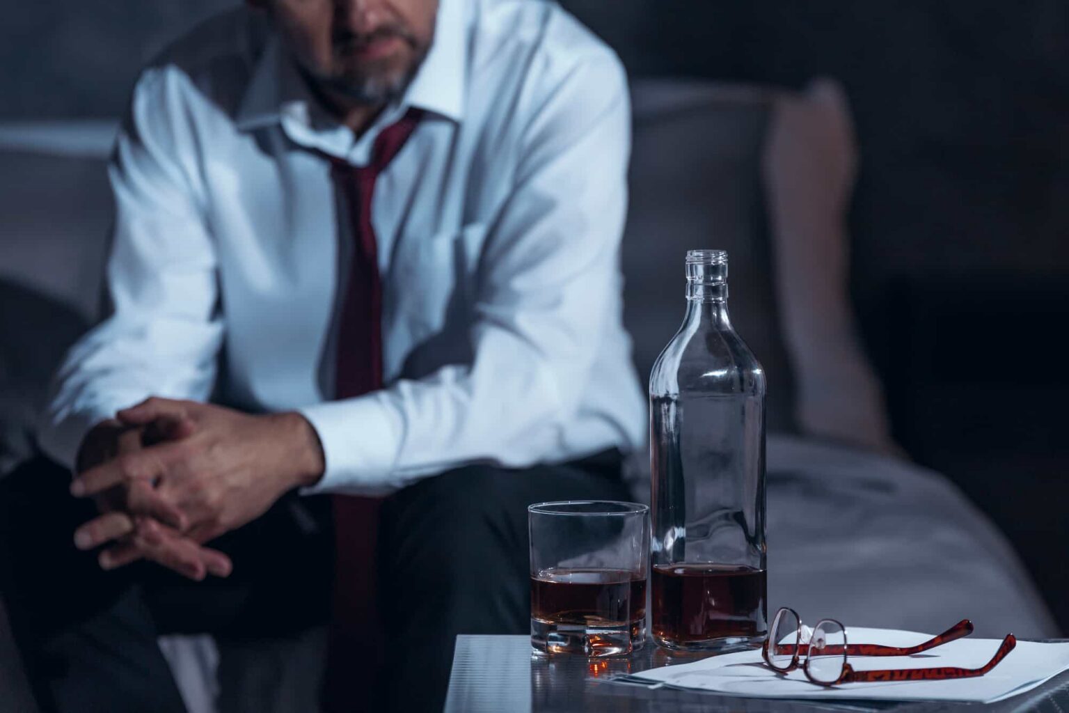 despondent man sitting beside alcohol bottle and g 2026 01 05 06 22 46 utc 1