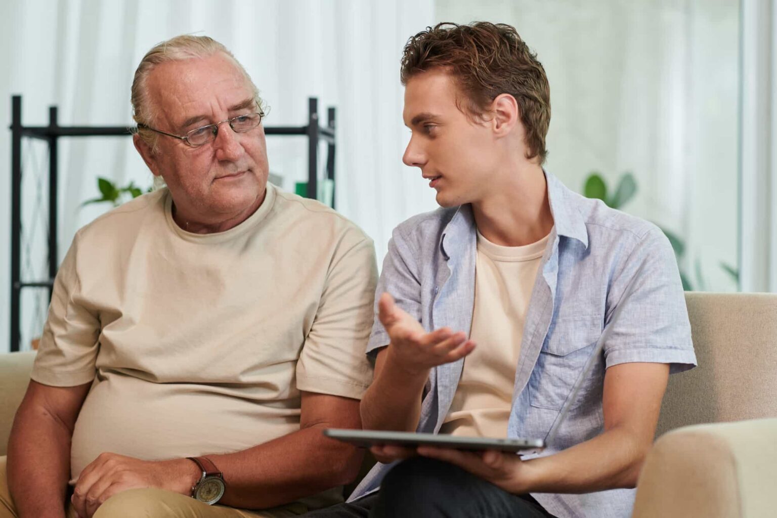 man and young adult talking with tablet indoors 2026 01 08 00 09 59 utc 1