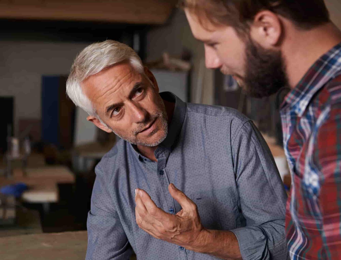 men discussing a woodworking project in workshop 2026 03 25 02 28 02 utc 1