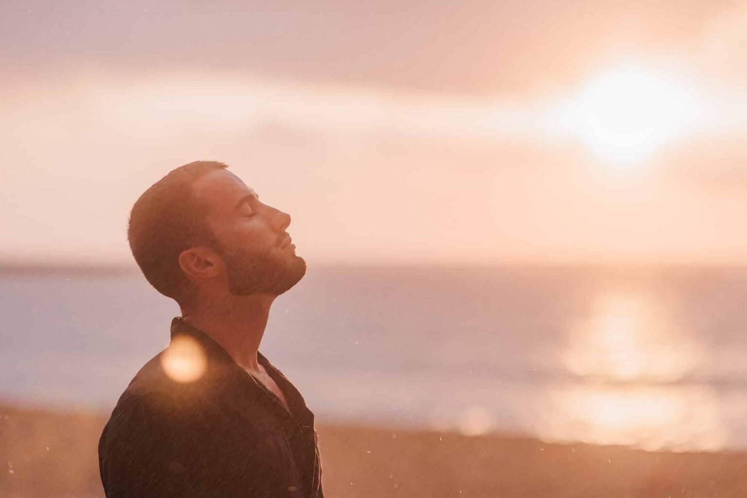 peaceful man meditating on the beach at sunset 2026 09 01 20 05 09 utc 1