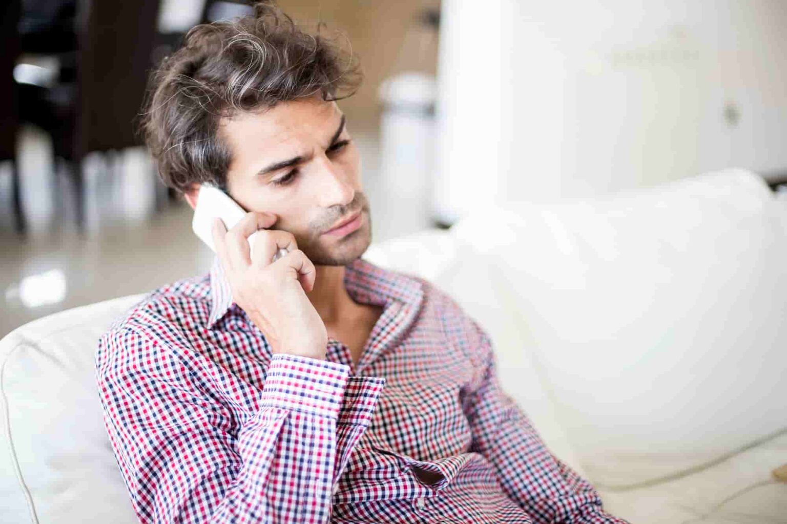 thoughtful man talking on smartphone indoors 2026 03 19 05 44 02 utc 1